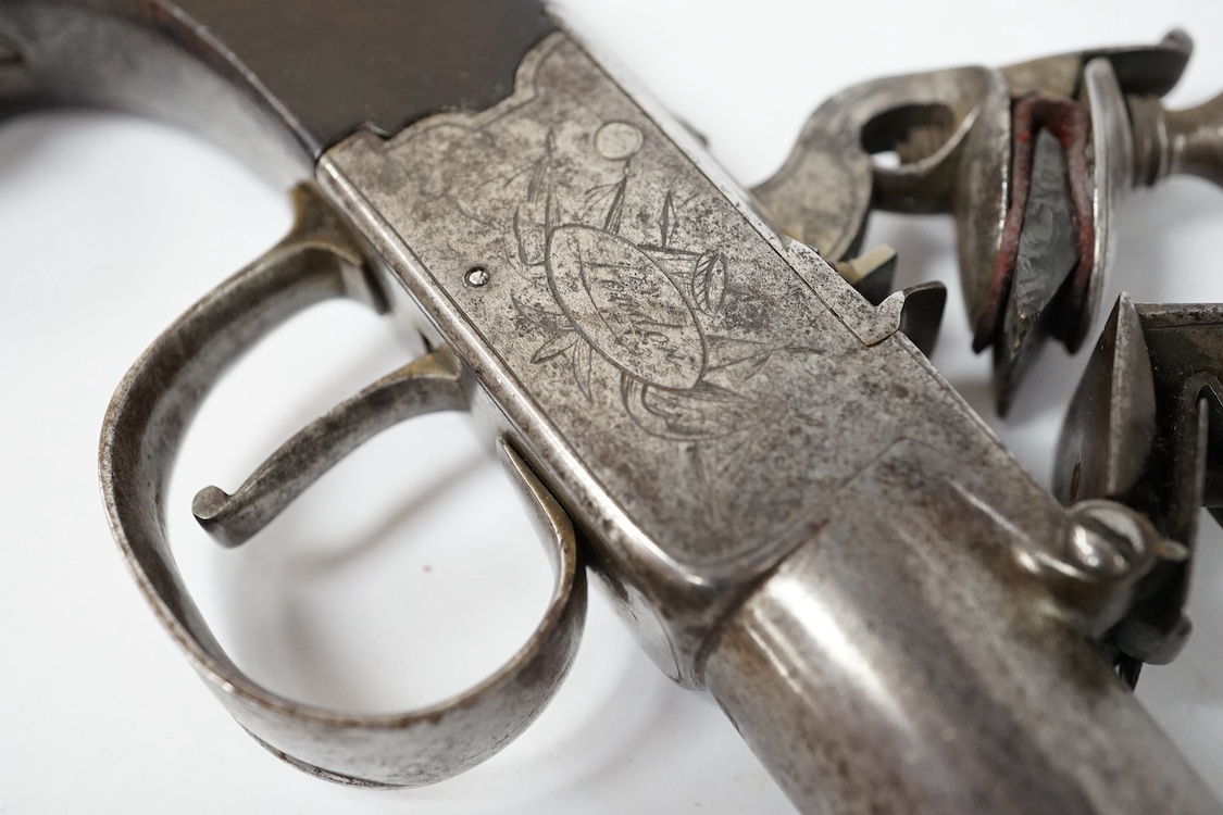 A 16 bore boxlock flintlock overcoat pistol by Ezekiel Baker, with turn off barrel, 11.5cm, London proved, frame signed within ovals upon flag trophies, sliding top thumb safety locks frizzen fence, slab walnut grip, 27c